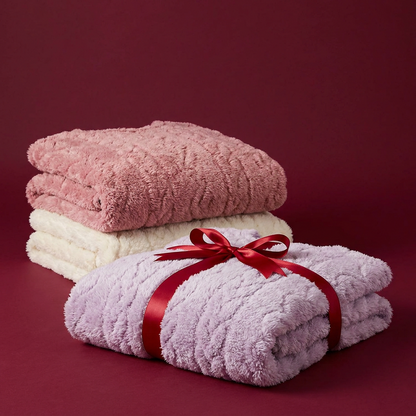 Three Avenzo Cosy Pyjama Sets stacked with a gift ribbon
